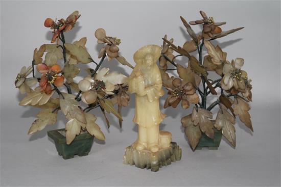 A Chinese soapstone figure and two hardstone models of trees